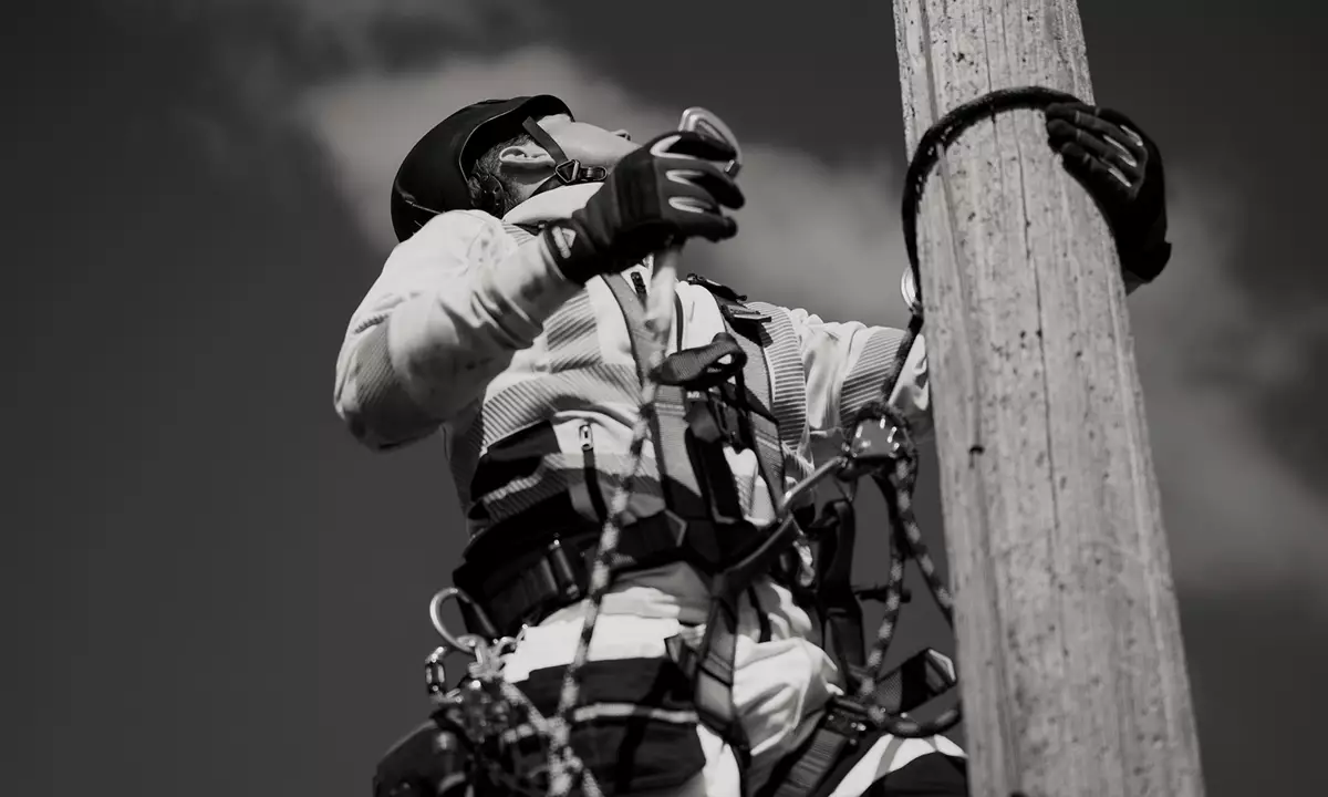 height worker climbing a pole